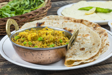 Indian Cuisine Mattar Paneer is a Vegetarian North Indian Dish Consisting of Peas And Paneer in a Tomato Based Sauce, Spiced with Garam Masala. It is often Served with Indian type of Tandoori Roti