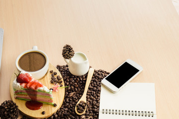 Cup of coffee and cake on the table with copy space background.