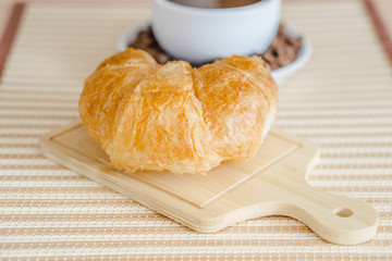 Cup of coffee and cake on the table with copy space background.