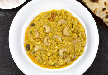 Indian Traditional Vegetarian Cuisine Kaju Curry Also Called Kaju Butter Masala Served with Tandoori Roti, Raita, Salad And Papad