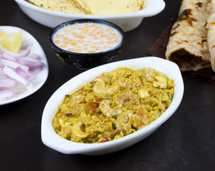 Indian Traditional Vegetarian Cuisine Kaju Curry Also Called Kaju Butter Masala Served with Tandoori Roti, Raita, Salad And Papad