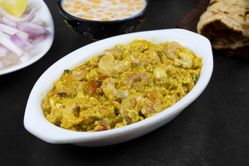 Indian Traditional Vegetarian Cuisine Kaju Curry Also Called Kaju Butter Masala Served with Tandoori Roti, Raita, Salad And Papad