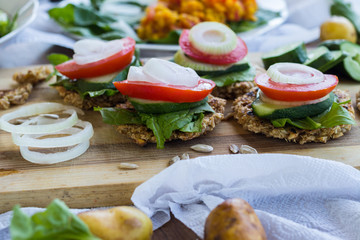 Vegan sandwiches on whole wheat bread with onion rings, tomatoes. fresh salad leaves, and cucumber slices with lemon juice. Vegetables diet for lunch and dinner. Raw vegetarian healthy food