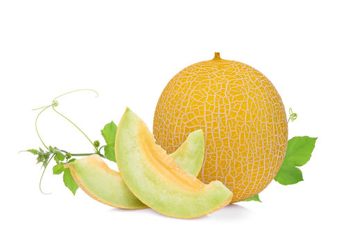 whole and slice of  pearl orange melon with green leaf isolated on white background