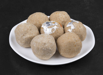 Gehu Ke Laddu Indian Traditional Sweet Food Also Know as Wheat Laddu, Laddoos, laddoo, ladoo, laddo Are Ball-Shaped Sweets Popular in The Indian Festivals. Laddu on Black Textured Background