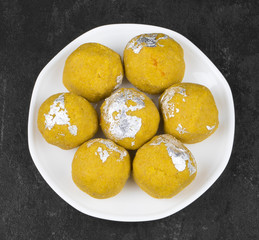 Besan Laddu Indian Traditional Sweet Food Also Know as Laddoos, laddoo, ladoo, laddo Are Ball-Shaped Sweets Popular in The Indian Festivals. Laddu on Black Textured Background