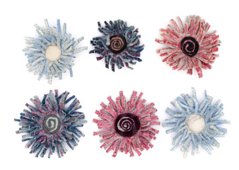 Products made of fulled wool in the form of chrysanthemum flowers on a white background