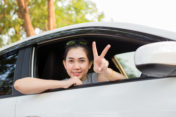 Woman drives a car and smiling