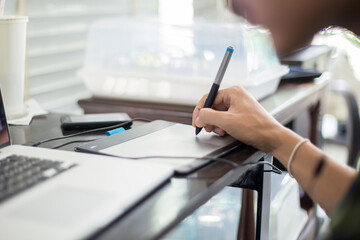 Fototapeta premium People writing on notebook and work with calculator and laptop on wooden table