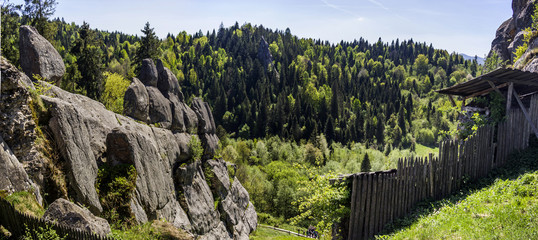 Fototapeta premium Tustan fortress place. A Medieval cliff-side fortress-city, archaeological and natural monument in Lviv region of Western Ukraine