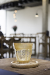 Finished drink of latte coffee on wooden saucer