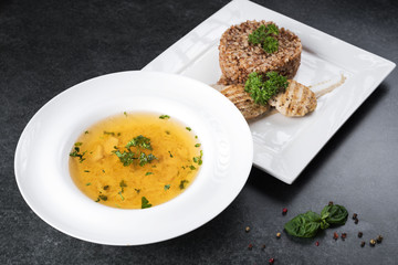 Complex dinner. Buckwheat porridge with dietary meat on a white plate is tenderly served