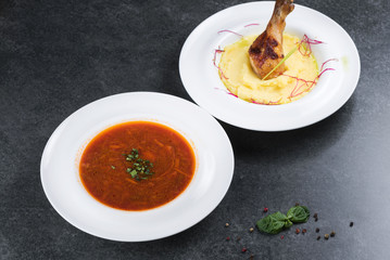 Complex dinner. Mashed potatoes with chicken leg appetizing on a white plate