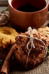 Cookies with cinnamon and tea on a burlap napkin, selective focus, close-up, top view, vertical.