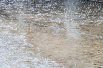 The Heavy rain drops on concrete floor