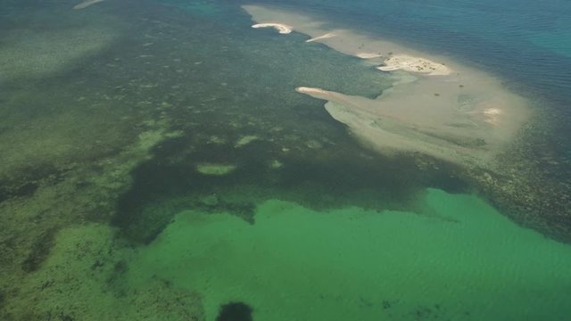 Tropical island with white sandy beach. Aerial view of sandy Cory island with colorful reef. Seascape, ocean and beautiful beach. Philippines, Anda, Pangasinan. Travel concept.