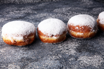 German donuts with jam and icing sugar. Carnival powdered sugar raised donuts