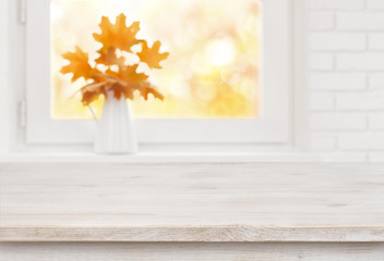 Bleached wooden table on the background of white autumn windowsill