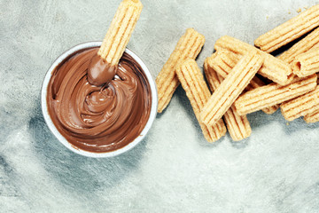 Traditional Spanish dessert churros with sugar and chocolate