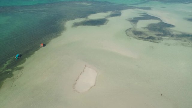 Tropical island with white sandy beach. Aerial view of Tondol White Sand Beach with colorful reef. Seascape, ocean and beautiful beach. Philippines, Anda, Pangasinan. Travel concept.