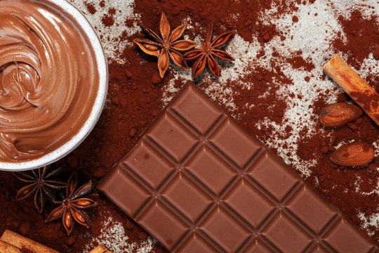 Chocolate bars on table with chocolate powder.