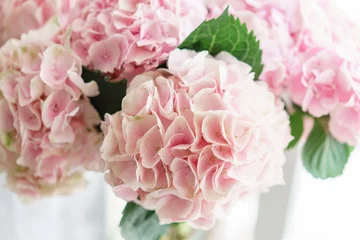 Photo sur Plexiglas Hortensia beautiful hydrangea flowers in a vase on a table . Bouquet of light blue, lilac and pink flower. Decoration of home. Wallpaper and background. Vertical photo