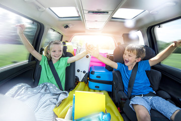 Children relax in the car during a long car journey
