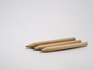 Three pencils on a white background