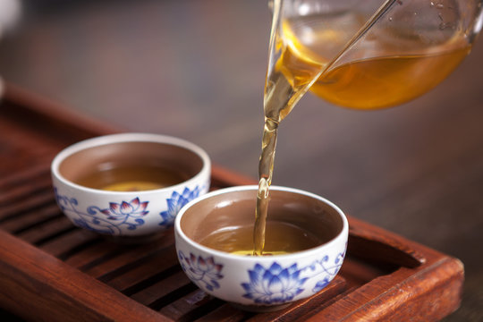 Cropped Shot Of Pouring Tea In Traditional Chinese Teaware.