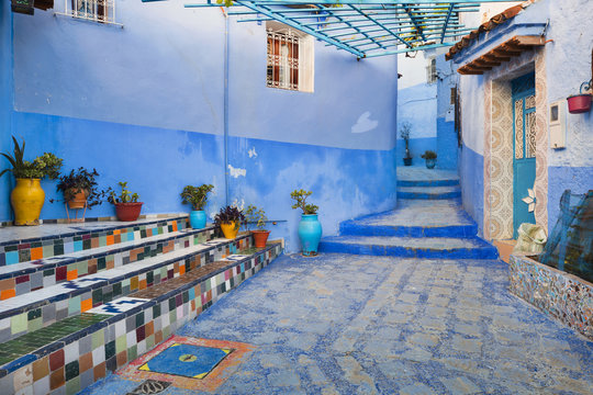 colored steps of stairs with vases in old city in Morocco