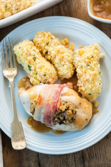 Black pudding & apple stuffed chicken breasts wrapped in bacon with a roast chicken gravy and potato croquettes