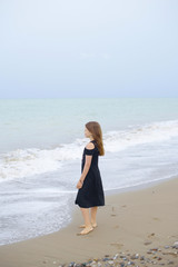Fototapeta na wymiar beautiful teen girl near the calm sea