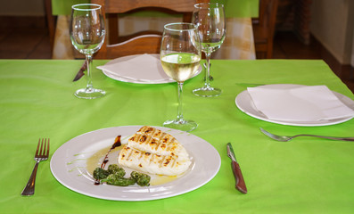 Codfish on plate in a restaurant table