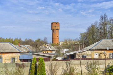 Fototapeta na wymiar Old Red Water Tower in the village