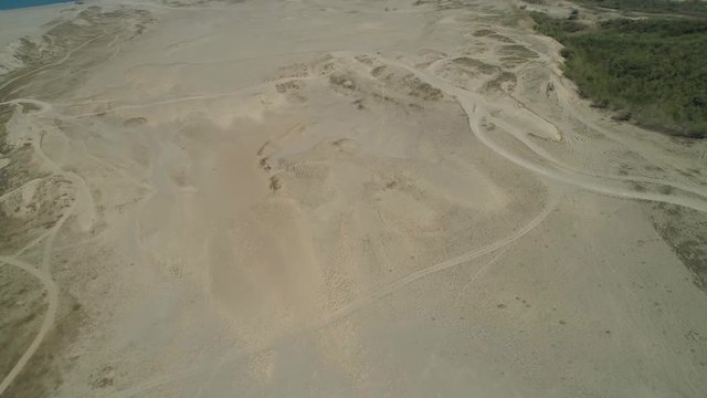 Aerial view of beautiful lonely beach and Paoay sand dune. Philippines, Luzon. Sand dunes near to the sea with sky. Ilocos Norte.