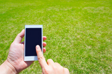 Images using smartphones at home garden or park.  家の庭や公園でスマートフォンを使っているイメージ