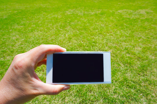 Images using smartphones at home garden or park.  家の庭や公園でスマートフォンを使っているイメージ
