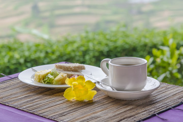 Close-up of black tea in white cup on the background of desert