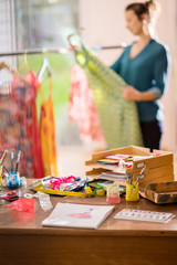 Fashion designer working on a new model, in her studio
