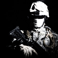 Shoulder portrait of war, military conflict combatant, army special forces soldier, counter terrorist forces fighter armed with rifle in combat helmet, glasses and mask cropped on black background