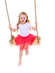 Little girl swinging on a swing