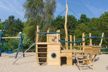 Children's playground with a wooden boat to climb