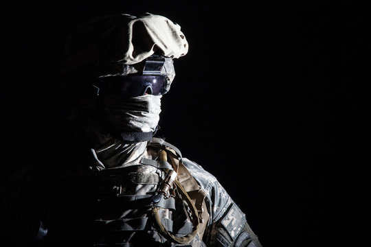 Close up portrait of modern infantry soldier, active army fighter, military mercenary in helmet, face hidden with balaclava and glasses high contrast, cropped on black background. Hybrid war concept