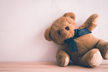 Teddy bear doll on white wall background - Retro tone