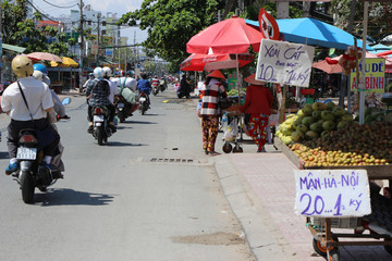 Vietnam street market.  lady seller.