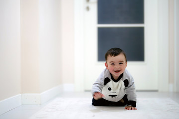 close up of funny baby boy crawling on carpet at home