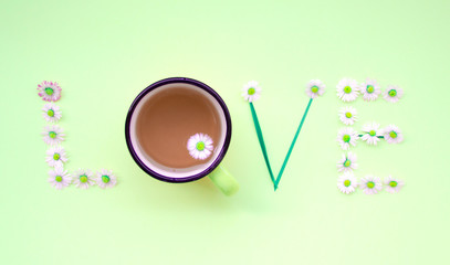 Love message written with flowers on green background. Individual Love concept.