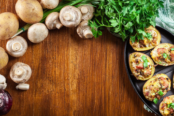 Baked potatoes in jacket stuffed with bacon, mushrooms and chees