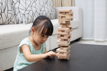 Asian Chinese little girl playing wooden stacks