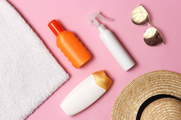 sunscreen, towel, hat, glasses on a colored background. Cosmetics for prevention of sunburn. top view, flatlay 